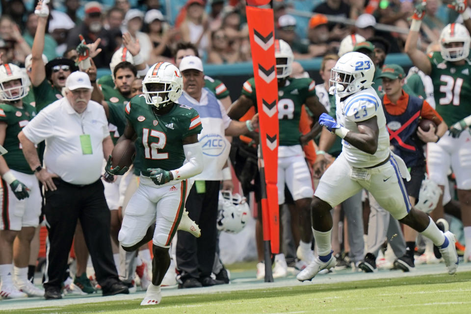 Miami wide receiver Brashard Smith (12) runs to score a touchdown past Central Connecticut State safety Zibassie Edwards (23) during the first half of an NCAA college football game, Saturday, Sept. 25, 2021, in Miami Gardens, Fla. (AP Photo/Lynne Sladky)