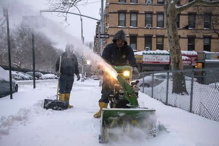 A man plows a sidewalk after a snow storm in the Brooklyn borough of New York January 27, 2015. REUTERS/Stephanie Keith