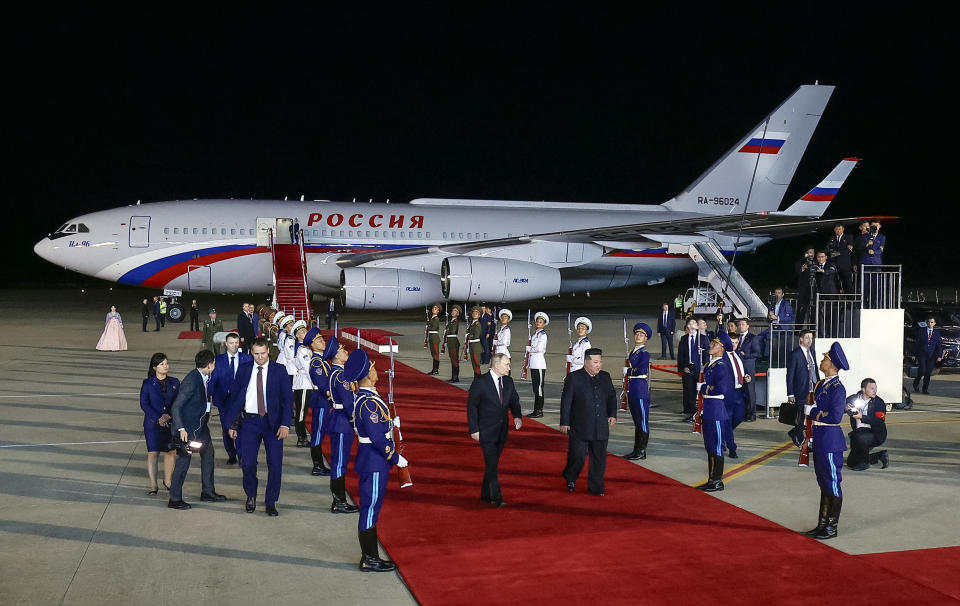 Russian President Vladimir Putin, center left, and North Korea's leader Kim Jong Un, center right, walk together during their meeting at the Pyongyang Sunan International Airport outside Pyongyang, North Korea, on Tuesday, June 18, 2024. (Vladimir Smirnov, Sputnik, Kremlin Pool Photo via AP)