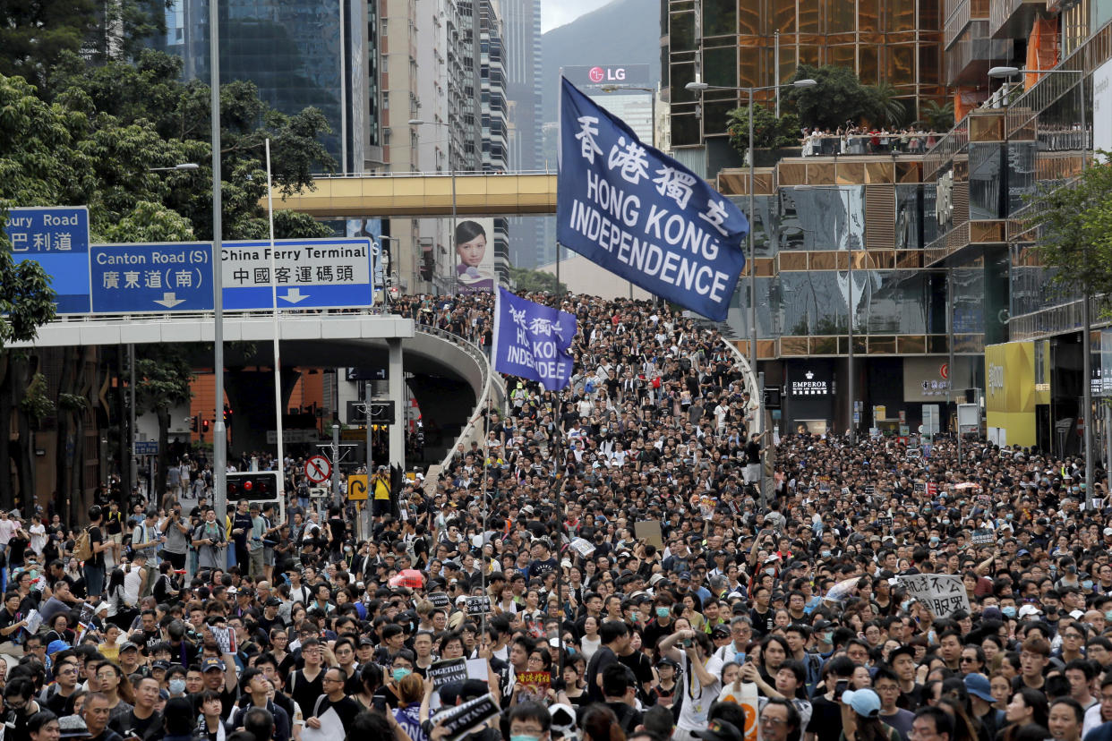 Protesters march with a flag calling for Hong Kong independence in Hong Kong on 7 July, 2019. (PHOTO: AP)