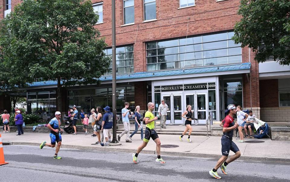 Participants in the Ironman 70.3 Pennsylvania Happy Valley run past the Berkey Creamery on the Penn State campus Sunday, July 2, 2023. Steve Manuel/For the CDT