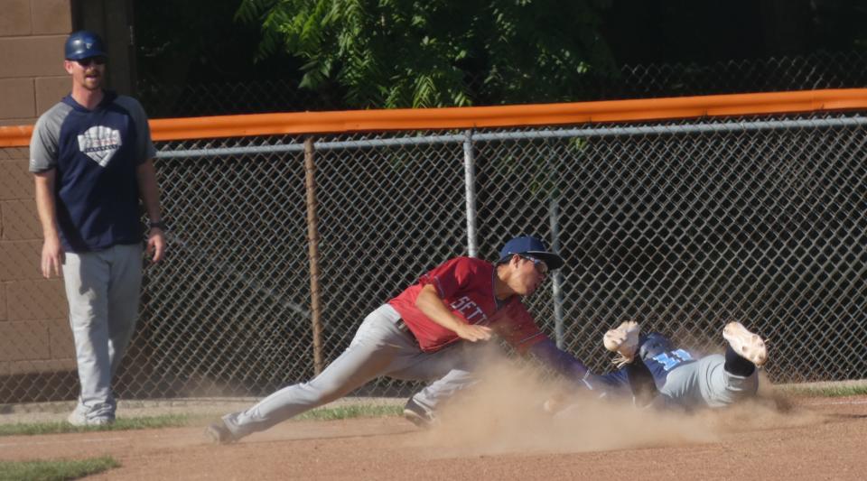 Licking County Settlers third baseman Jumpei Ohashi tags out Xenia Scouts' Peyton Niemann during Great Lakes Summer Collegiate League play at Heath's Dave Klontz Field on Friday, June 24, 2022. The Settlers fell to the visiting Scouts 9-1.