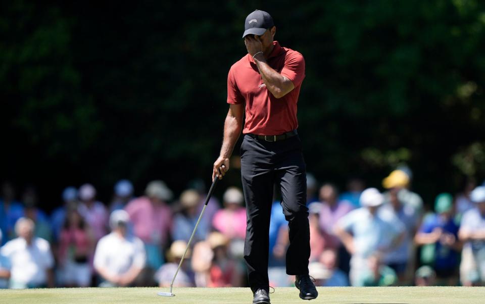 Tiger Woods wipes his face on the 15th