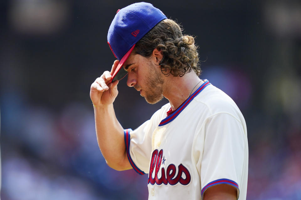 Philadelphia Phillies pitcher Aaron Nola walks off the field after the fifth inning of a baseball game against the Colorado Rockies, Sunday, Sept. 12, 2021, in Philadelphia. (AP Photo/Matt Slocum)