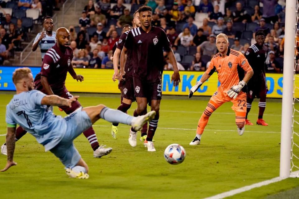 Sporting Kansas City forward Johnny Russell (left) takes a shot that was blocked by Colorado Rapids defender Auston Trusty during the second half of an MLS soccer match Saturday, Aug. 28, 2021, at Children’s Mercy Park in Kansas City, Kan. 