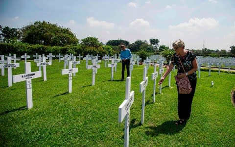 Family members pay their respects to the 915 Dutch soldiers killed in the battle of the Java Sea at the Dutch war cemetery Ereveld in Surabay - Credit: AFP