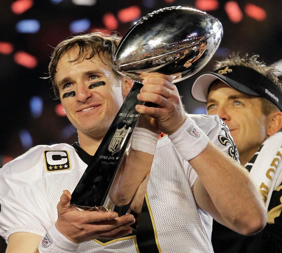 File-This Feb. 7, 2010, file photo shows New Orleans Saints quarterback Drew Brees (9) celebrating with the Vince Lombardi Trophy after the Saints' 31-17 win over the Indianapolis Colts in the NFL Super Bowl XLIV football game in Miami.
