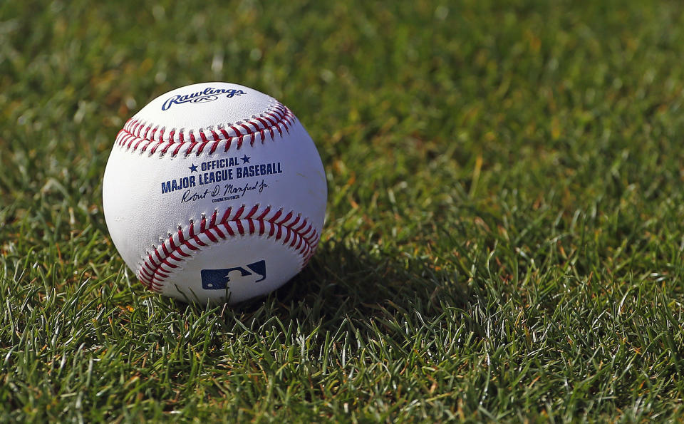 FILE - In this Feb. 17, 2017, file photo, a baseball is shown on the grass at the Cincinnati Reds baseball spring training facility in Goodyear, Ariz. Major League Baseball rejected the players' offer for a 114-game regular season in the pandemic-delayed season with no additional salary cuts and told the union it did not plan to make a counterproposal, a person familiar with the negotiations told The Associated Press. The person spoke on condition of anonymity Wednesday, June 3, 2020, because no statements were authorized. (AP Photo/Ross D. Franklin, FIle)