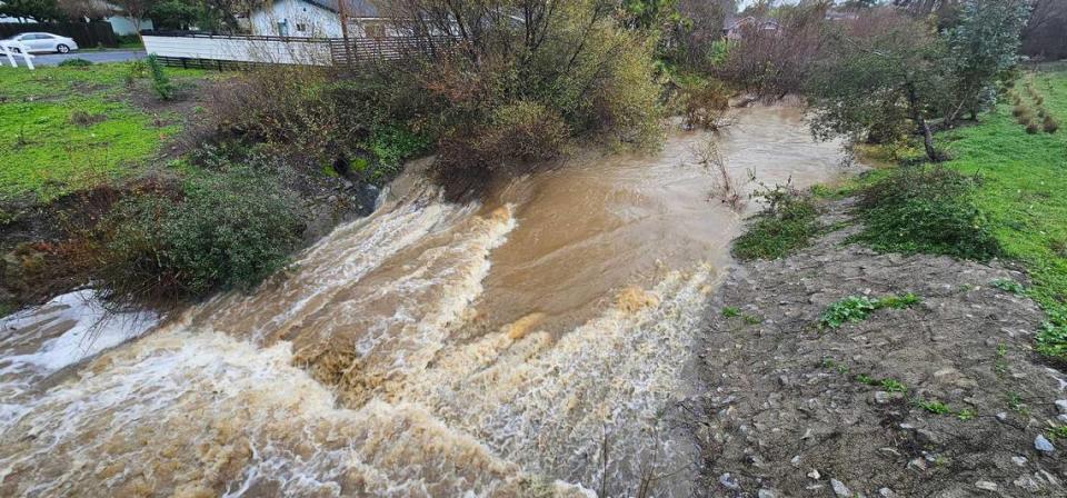 Laguna Lake rose well above its usual elevation during a storm, and spilled out underneath Madonna Road, on Feb. 19, 2024. The overspill also fed to the area below the Froom Ranch Way bridge near Dick’s Sporting Goods, creating a fast-moving creek.