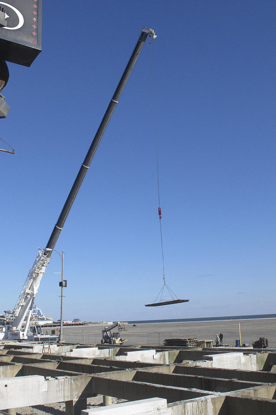 A project to replace part of the boardwalk in Wildwood N.J. was under way in this this Nov. 19, 2021 photo. On Feb. 23, 2024, New Jersey selected 18 Jersey Shore towns to split $100 million in funds to repair or rebuild their boardwalks. (AP Photo/Wayne Parry)