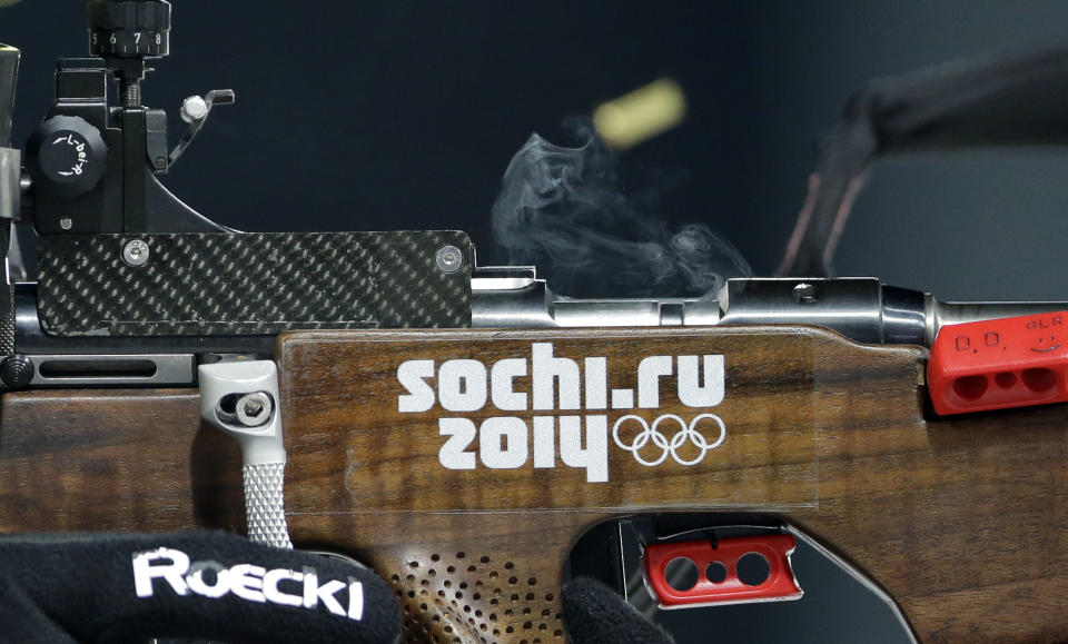 A cartridge flies out from the rifle of Belarus' Darya Domracheva during the women's biathlon 12.5k mass-start, at the 2014 Winter Olympics, Monday, Feb. 17, 2014, in Krasnaya Polyana, Russia. (AP Photo/Lee Jin-man)