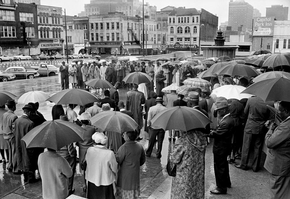 Black church leaders and other demonstrators huddle under umbrellas as they participate in a "prayer vigil" at the Metro Courthouse on April 28, 1963. The group stood for an hour in the rain to petition local government leaders "to provide justice and equality for all Nashville citizens."