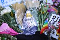 Flowers and tributes are seen as people gather in front of the U.S. Supreme Court following the death of U.S. Supreme Court Justice Ruth Bader Ginsburg, in Washington