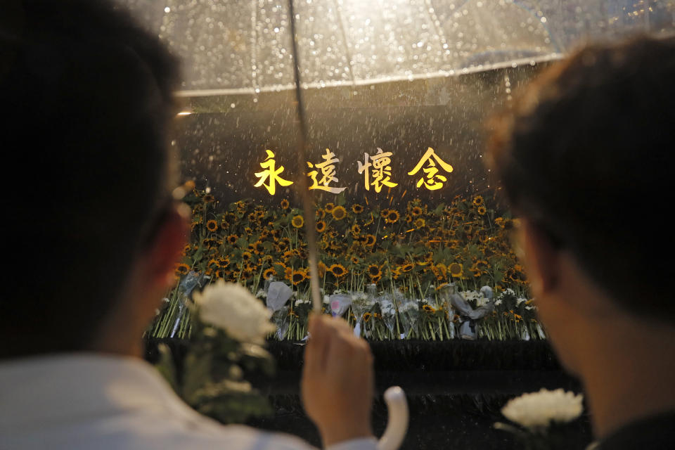 Attendees take part in a public memorial for Marco Leung, the 35-year-old man who fell to his death weeks ago after hanging a protest banner against an extradition bill, in Hong Kong, Thursday, July 11, 2019. The parents of Leung urged young people to stay alive to continue their struggle. (AP Photo/Kin Cheung)