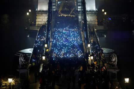 Demonstrators march during a protest against a proposed new labor law, billed as the "slave law", at the Chain Bridge in Budapest, Hungary December 21, 2018. REUTERS/Bernadett Szabo