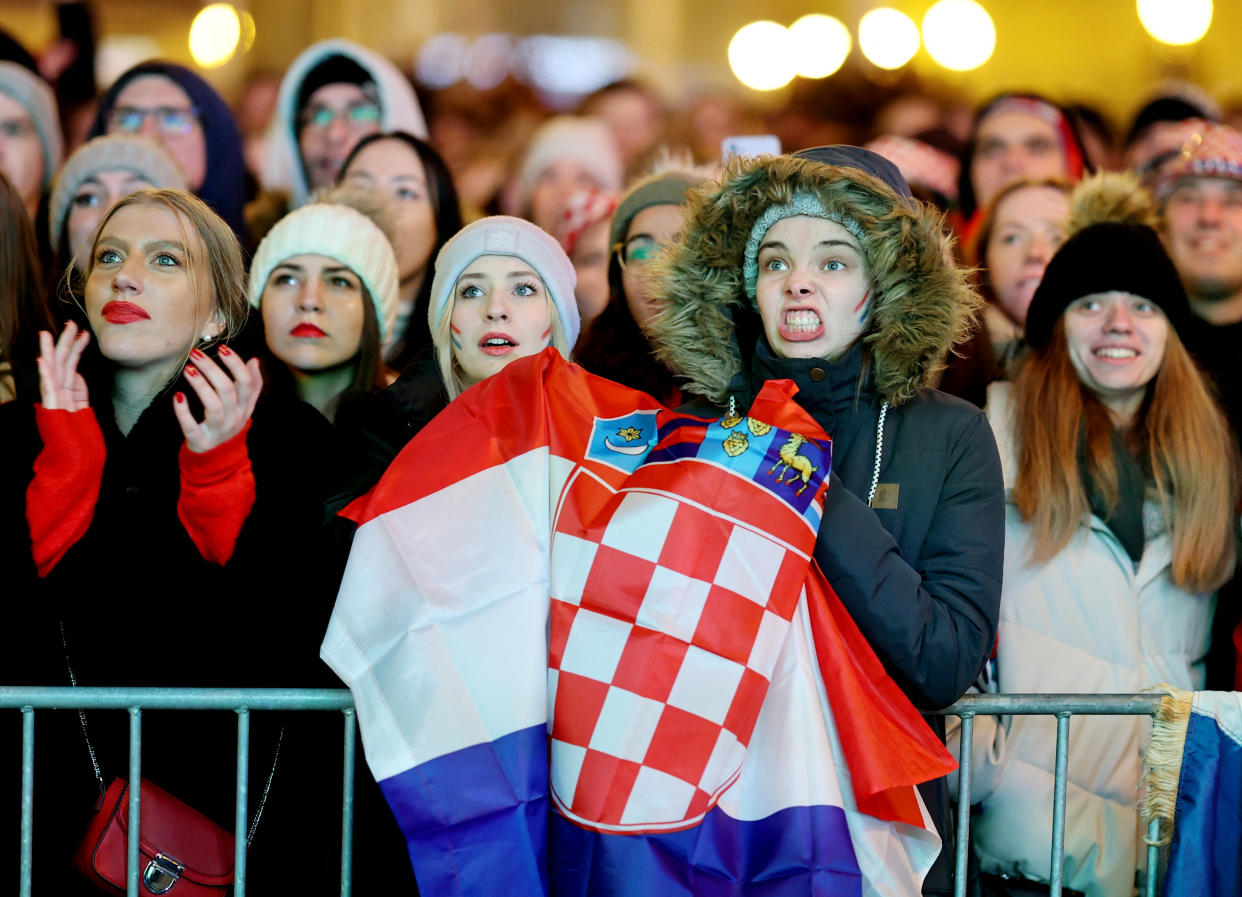 Soccer Football - FIFA World Cup Qatar 2022 - Fans in Zagreb watch Argentina v Croatia - Zagreb, Croatia - December 13, 2022 Croatia fans react as they watch the match at the Ban Josip Jelacic Square REUTERS/Antonio Bronic