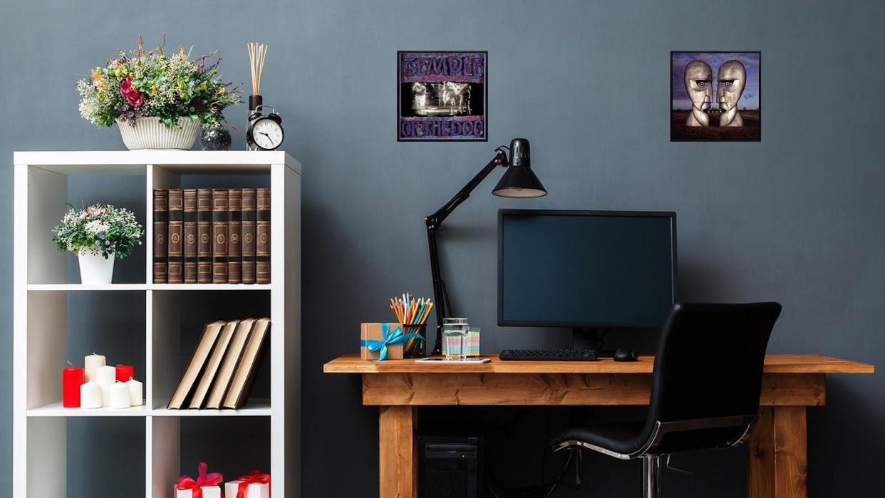  A photograph of a home office with two LPs wall-mounted above a desk. 