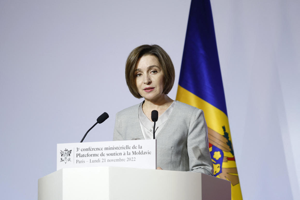 Moldovan President Maia Sandu at the microphone, with the Moldovan flag behind her, and a placard marked in French: Third Ministerial Conference in support of Moldova, Paris, Monday, Nov. 21, 2022.