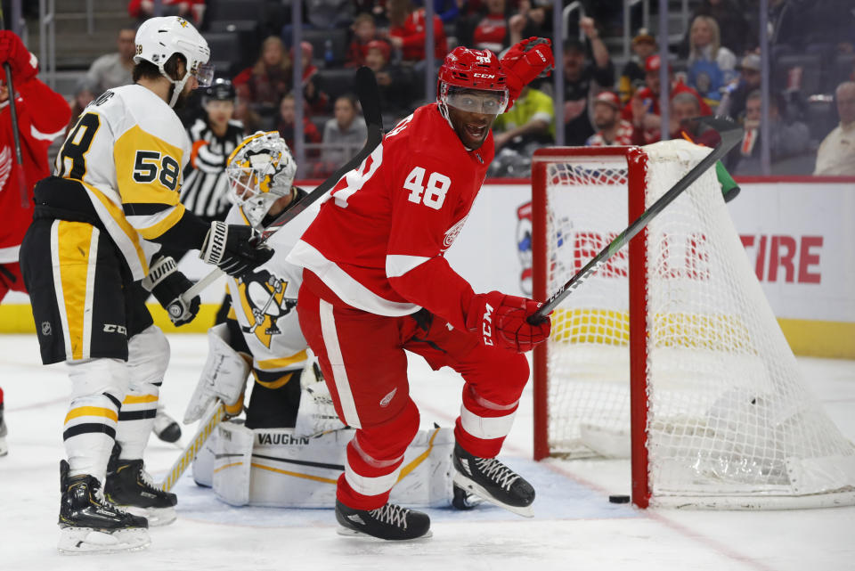 Detroit Red Wings right wing Givani Smith (48) celebrates a Filip Zadina goal against the Pittsburgh Penguins in the second period of an NHL hockey game Friday, Jan. 17, 2020, in Detroit. (AP Photo/Paul Sancya)