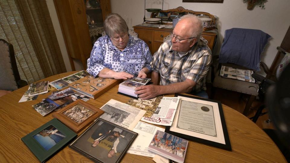 PHOTO: Denise Tucholke, left, and Clayton Tucholke look through family photo albums inside their Milbank, S.D. home.  (ABC News)