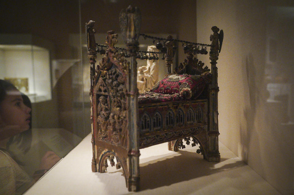 A work from the Netherlands, "Crib of the Infant Jesus"—a 1974 gift from Ruth Blumka to the Metropolitan Museum of Art—is shown on exhibition at the museum Thursday, Sept. 1, 2022, in New York. The creation is among 53 works in the museum's collection, once looted during the Nazi era, but returned to their designated owners before being obtained by the museum through donation or sale. (AP Photo/Bebeto Matthews)