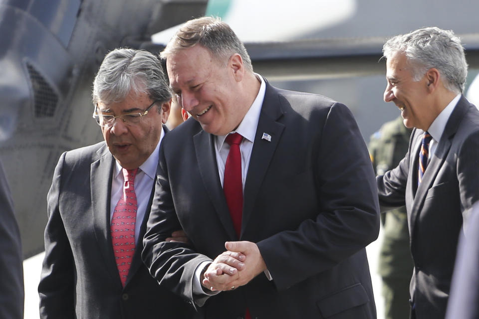 U.S. Secretary of State Mike Pompeo, front, speaks to Colombia's Defense Minister Carlos Trujillo during a visit to an anti-narcotics police in Bogota, Colombia, Tuesday, Jan. 21, 2020. (AP Photo/Ivan Valencia)