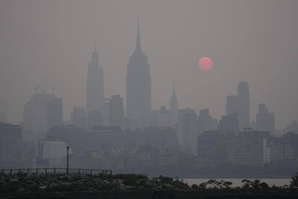 El sol se levanta sobre la silueta al horizonte de la Ciudad de Nueva York en medio de una bruma, en una vista desde Jersey City, Nueva Jersey, el miércoles 7 de junio de 2023. (AP Foto/Seth Wenig)