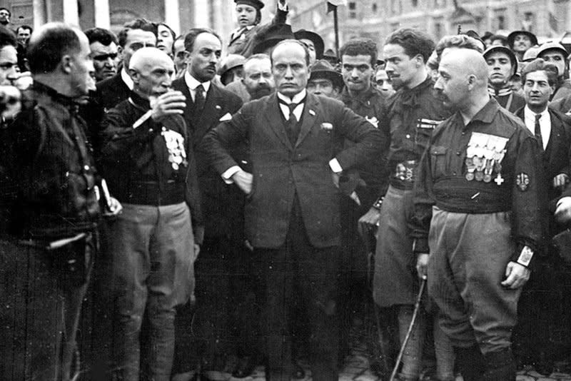 Benito Mussolini (C) poses with supporters in October 1922 during the fascists March on Rome. File Photo courtesy Wikipedia