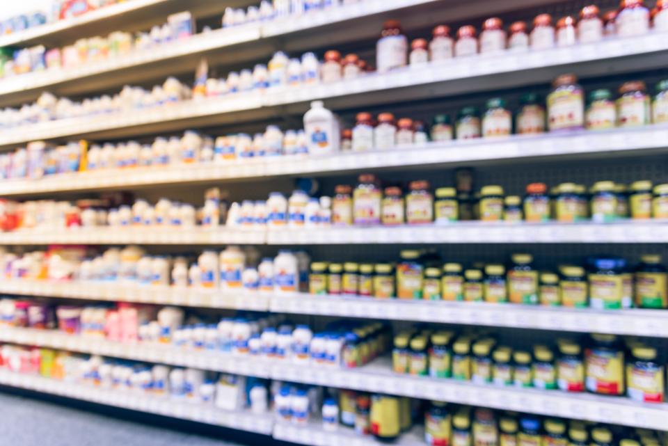 Vintage blurred image vitamin store shelves, huge variation of vitamins, supplements, natural remedies, functional food, lifestyle support, herbal.