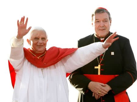 FILE PHOTO - Pope Benedict XVI (L) acknowledges the crowd of World Youth Day pilgrims before giving an address in Sydney July 17, 2008, as Australia's senior Catholic cleric Cardinal George Pell looks on. REUTERS/Mick Tsikas/File Photo