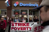 Demonstrators are pictured in front of Domino's Pizza during a strike aimed at the fast-food industry and the minimum wage in Seattle, Washington August 29, 2013. Fast-food workers went on strike and protested outside restaurants in 60 U.S. cities on Thursday, in the largest protest of an almost year-long campaign to raise service sector wages. REUTERS/David Ryder (UNITED STATES - Tags: FOOD CIVIL UNREST BUSINESS EMPLOYMENT)