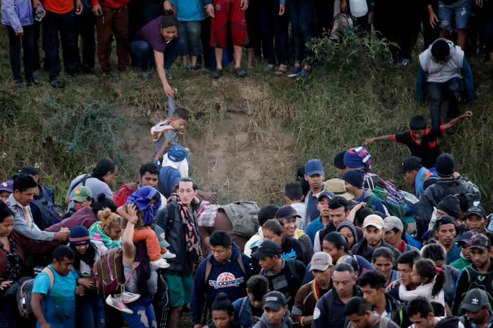 Migrants, mainly from Central America and marching in a caravan, walk after crossing the Suchiate river, on the outskirts of Ciudad Hidalgo