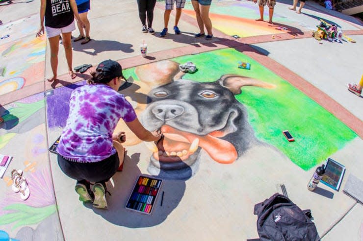 A sidewalk chalk artist puts the finishing touches on her entry during a previous Amarillo College Chalk It Up art contest. This year's event is scheduled for July 29 at the Washington Street campus.