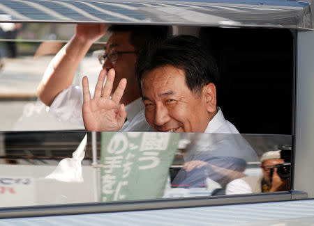 Japan's Constitutional Democratic Party leader Yukio Edano waves his hands from a car during an election campaign rally in Tokyo, Japan, October 10, 2017. REUTERS/Issei Kato