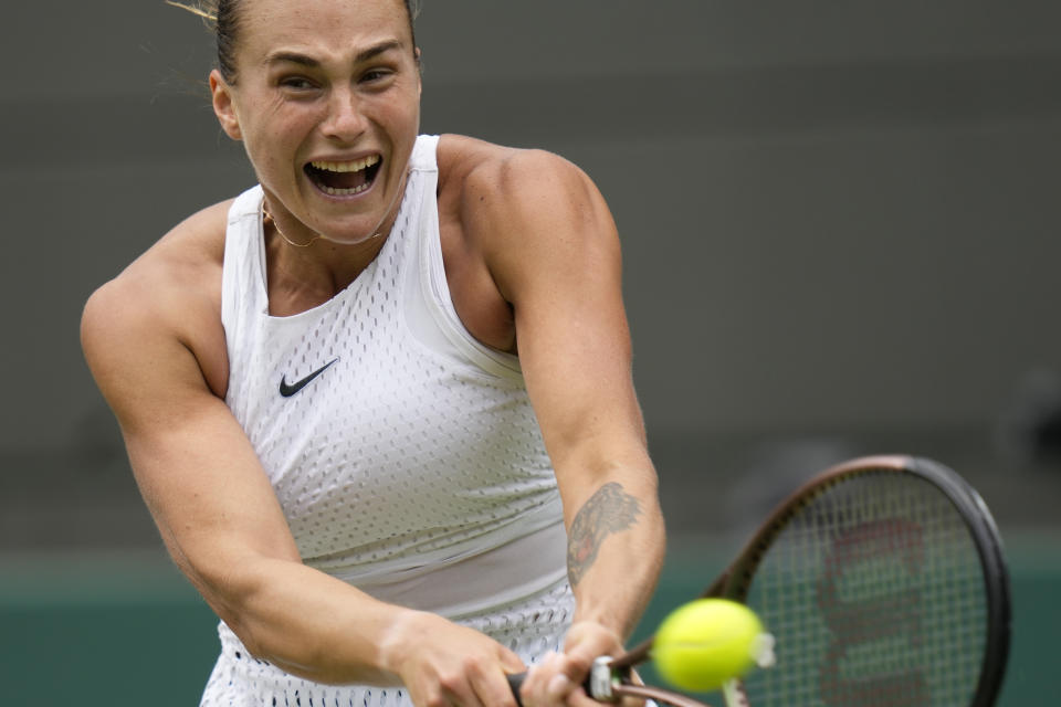 Aryna Sabalenka of Belarus in action against Russia's Ekaterina Alexandrova during their women's singles match on day eight of the Wimbledon tennis championships in London, Monday, July 10, 2023. (AP Photo/Kirsty Wigglesworth)