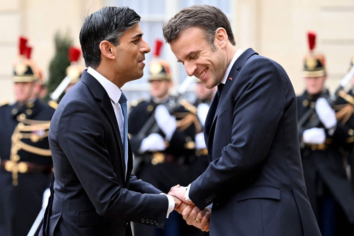 Emmanuel Macron shakes hands with Rishi Sunak as he arrives for Friday’s summit at the Elysee Palace (AFP/Getty)