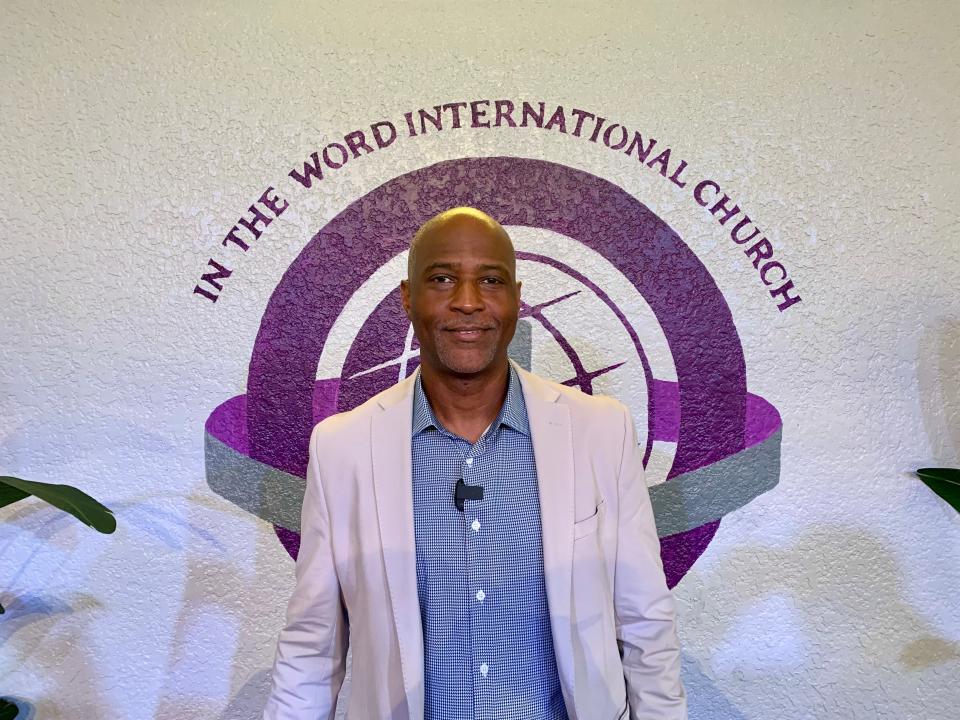 Pastor Harry Williams of In the Word International Church stands in front of the church's name on Friday, Sept. 13, 2024.