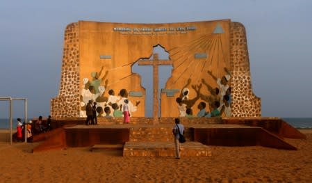 Tourists are seen at The Memorial of the Great Jubilee of 2000 monument at the historic slave port of Ouidah in Benin