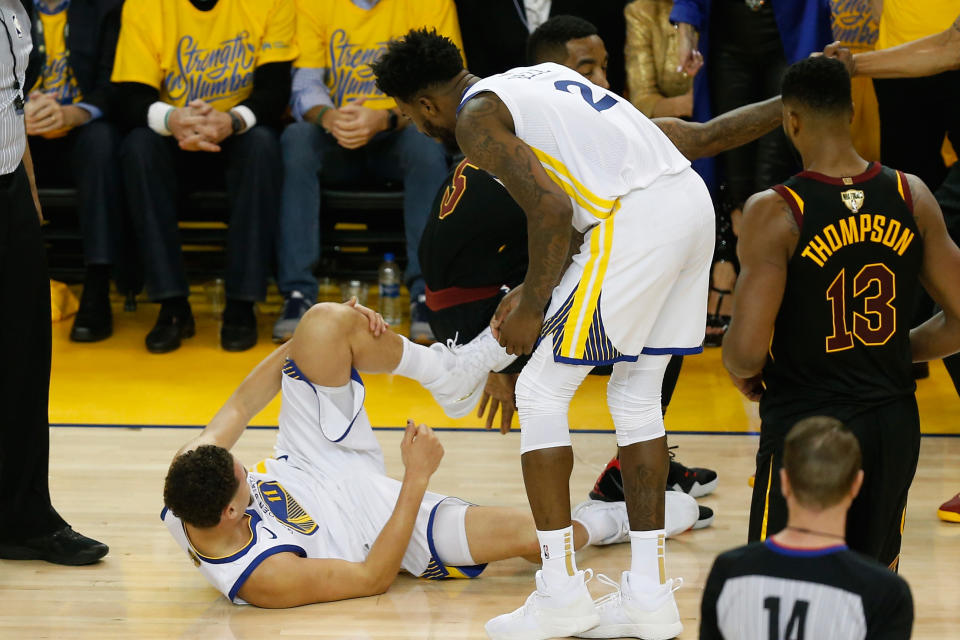 Klay Thompson holds his left leg in pain after being fouled by J.R. Smith early in the first quarter of Game 1 of the 2018 NBA Finals. (Getty)