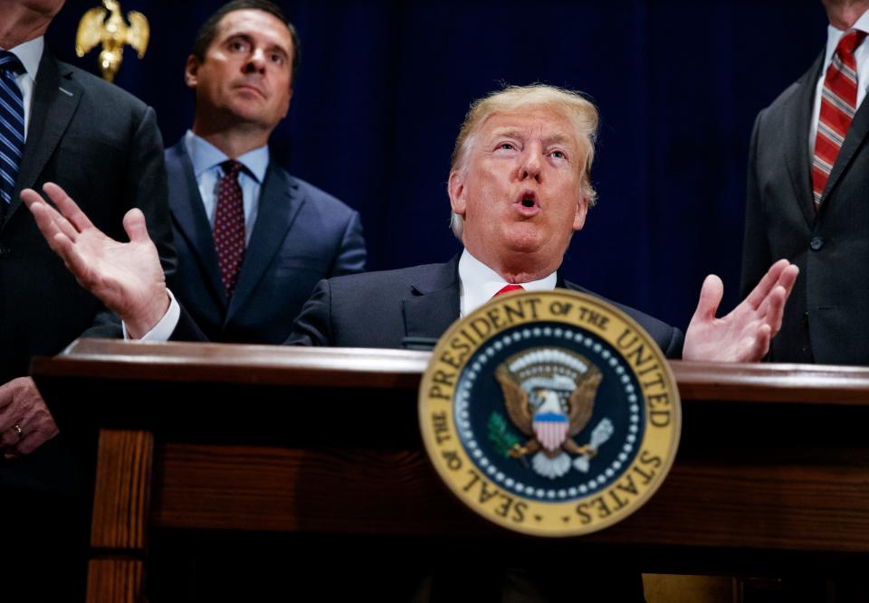 In this Oct. 19, 2018 file photo, former President Donald Trump speaks during a ceremony as former Rep. Devin Nunes, R-Calif. looks on. Trump was presenting one of the nation's highest civilian honors to Nunes.