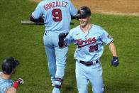 Minnesota Twins' Max Kepler, right, smiles as he scores on a solo home run to tie the baseball game in the eighth inning Tuesday, Sept. 22, 2020, in Minneapolis. (AP Photo/Jim Mone)