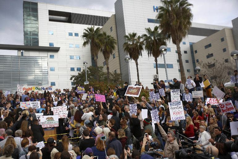 Sen. Kamala Harris, D-Calif., at podium, joins health care workers to save the Affordable Care Act across the country outside LAC+USC Medical Center in Los Angeles Sunday, Jan. 15, 2017. The rally was one of many being staged across the country in advance of President-elect Donald Trump's inauguration on Jan. 20. Trump has promised to repeal and replace the health care law, and the Republican-controlled Senate on Thursday passed a measure taking the first steps to dismantle it. (AP Photo/Damian Dovarganes)