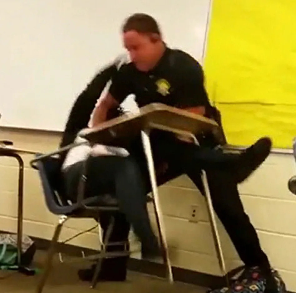 A police officer appears to body-slam a female student at a South Carolina high school in a still image from a cellphone video. (via NBC News)
