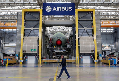An employee walks in front of an Airbus A380 at the final assembly line at Airbus headquarters in Blagnac near Toulouse, France, March 21, 2018. REUTERS/Regis Duvignau