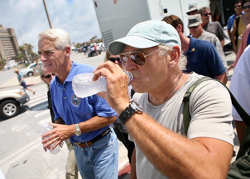 Musician Jimmy Buffet, joins Florida Governor Charlie Crist during his visit Pensacola Beach June 5, 2010 to inspect damage to the beaches of the west coast of Florida from oil spilled in the Gulf of Mexico. 