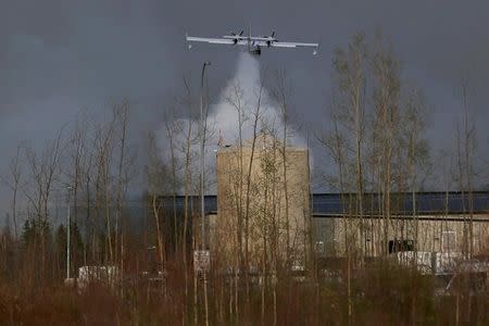 A plane dumps water on the wildfires near Fort McMurray, Alberta, Canada, May 6, 2016. REUTERS/Mark Blinch