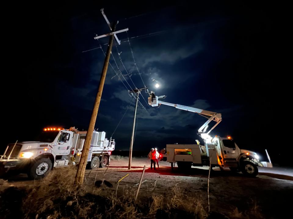 Workers repairing power lines after storm caused power outtages in 2022.