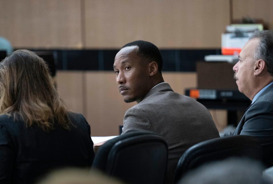  Travis Rudolph, center, with his defense attorneys Marc Shiner, right, and Heidi Peret during the murder trial of former Florida State University football player Travis Rudolph in West Palm Beach, Florida on May 26, 2023.