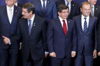 Cyprus President Nicos Anastasiades (L) Turkish Prime Minister Ahmet Davutoglu (C) and European Council President Donald Tusk take part in a group photo at a EU-Turkey summit in Brussels, Belgium, at which the EU will seek Turkish help to slow the influx of migrants into southeastern Europe, November 29, 2015. REUTERS/Yves Herman