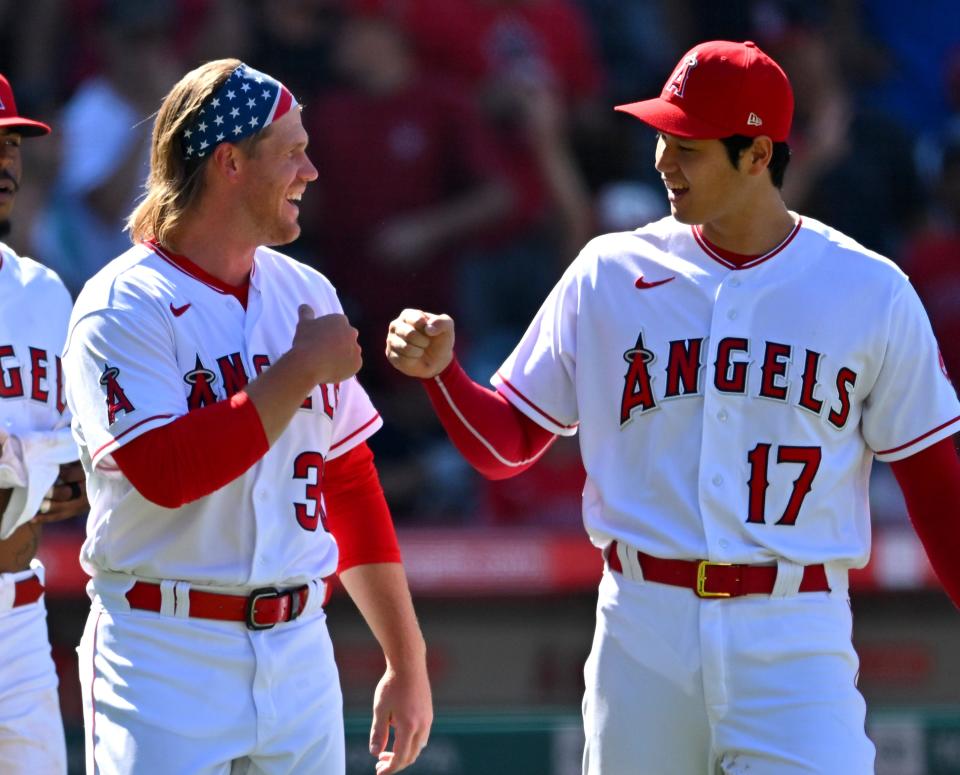 Los Angeles Angels first baseman David MacKinnon (39) and designated hitter Shohei Ohtani (17) fist bump after the final out of the ninth inning defeating the Seattle Mariners at Angel Stadium on June 26, 2022.